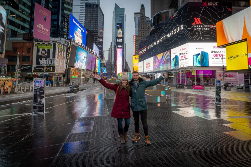 Woman and man standing in Times Square in New York