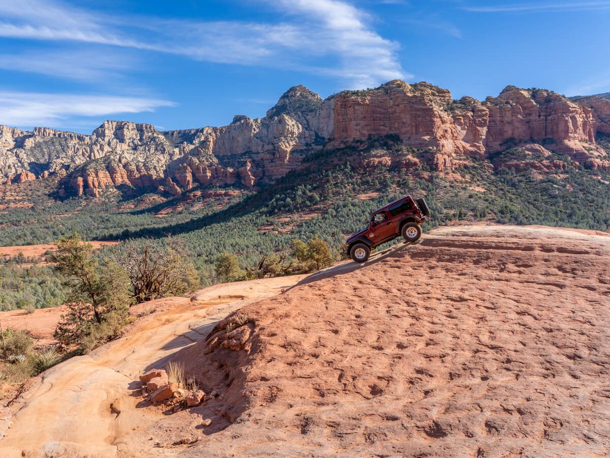 The slide in Sedona Arizona with a man driving a jeep down it