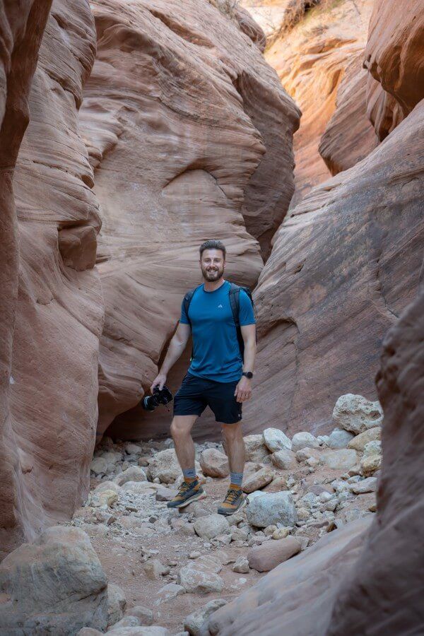 Man hiking with camera in Buckskin Gulch in Utah