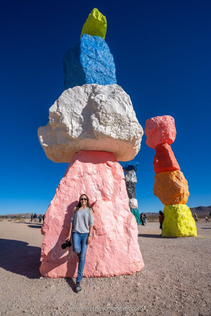 Wide angle photo of a boulder tower with paint in the desert
