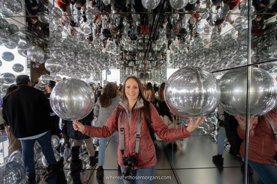 Affinity exhibit at SUMMIT One with a woman holding two large silver balloons
