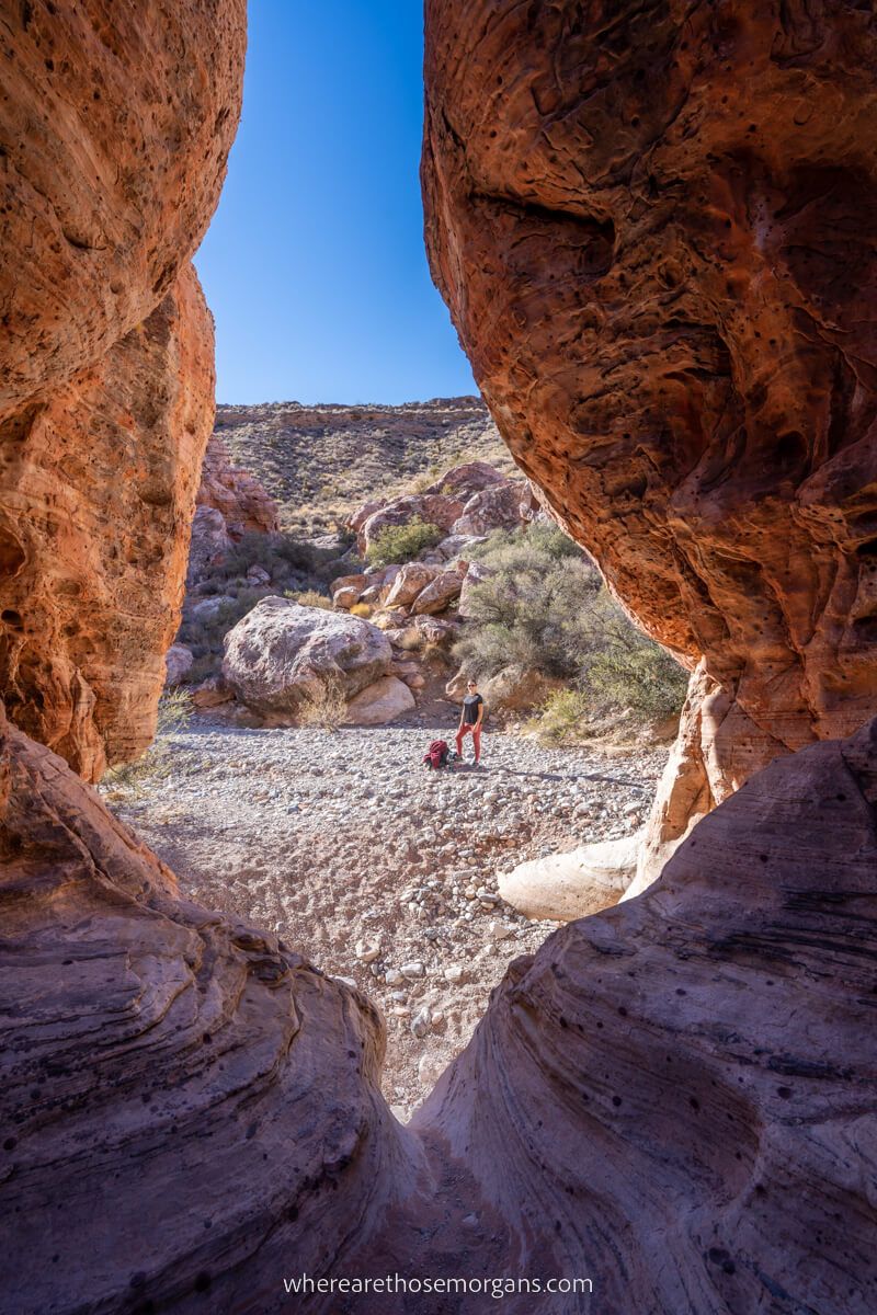 Hiking Calico Hills in Red Rock Canyon near Las Vegas photo taken through flame shaped rock formation one of the most popular hikes in the area