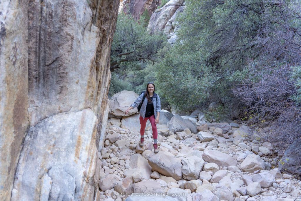 Hiker stepping across stones rocks and boulders in Ice Box Canyon the best adventure hike in Red Rock Canyon near Las Vegas