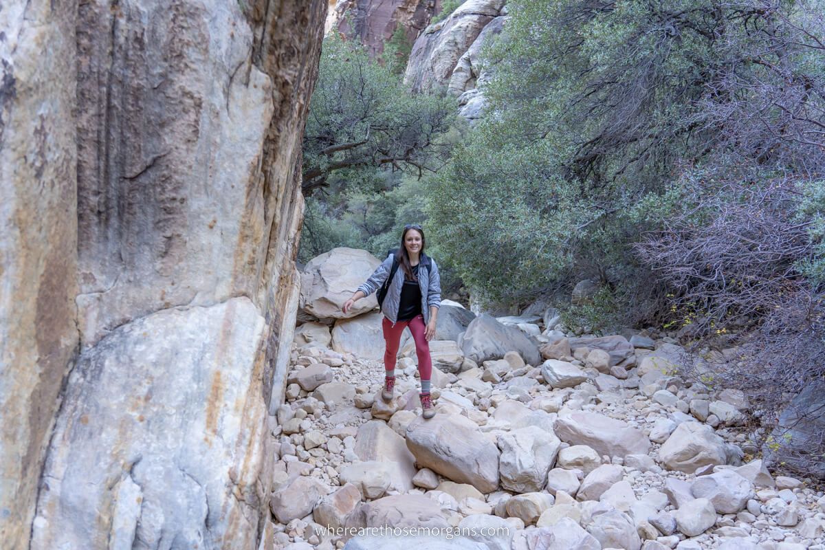 Hiker stepping across stones rocks and boulders in Ice Box Canyon the best adventure hike in Red Rock Canyon near Las Vegas