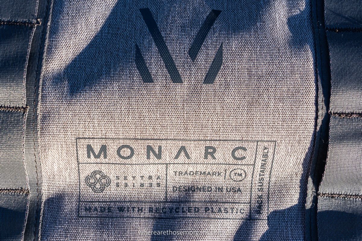 Monarc logo on their duffel backpack showing that its made from recycled bottles