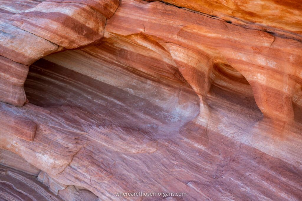 Sandstone rocks red and purple with eroded smooth holes