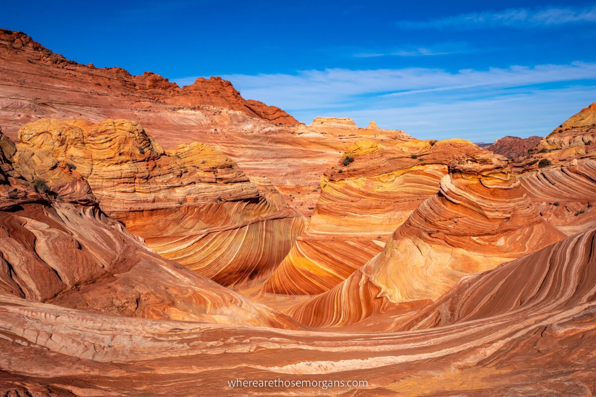 The Wave in Arizona filled with sunlight and blue sky similar to Fire Wave in Nevada but on a much bigger scale