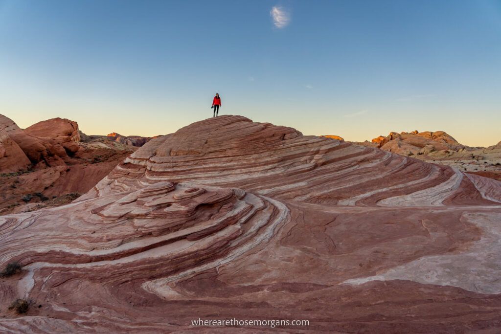 Hiking the amazing Fire Wave Trail and photographer taking sunrise photos of stunning swirling patterns