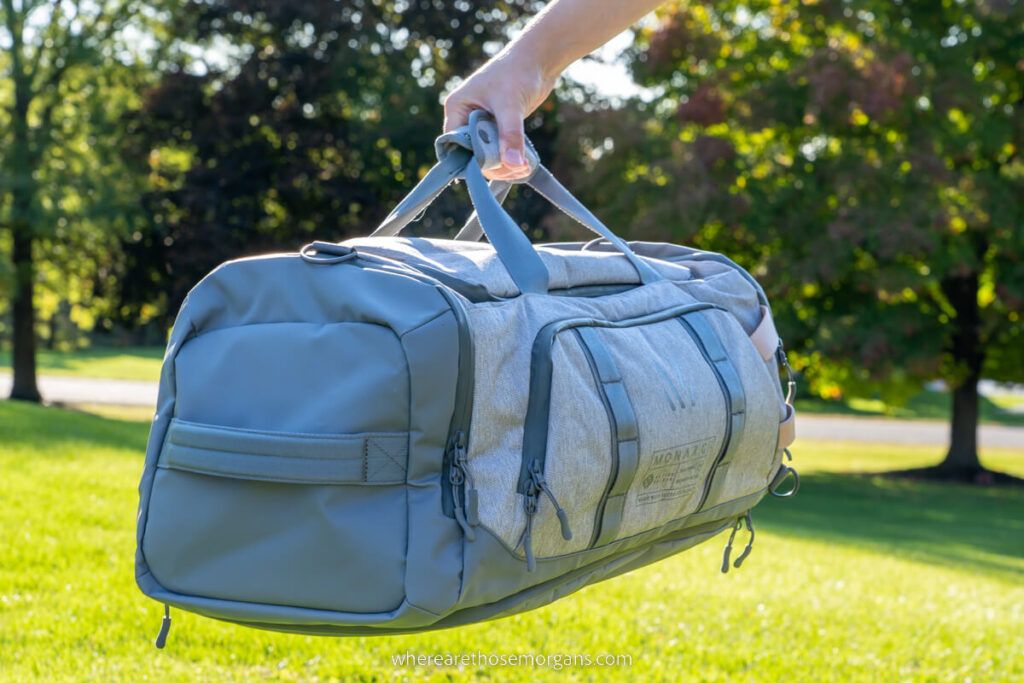 Man holding the Monarc Settra duffel backpack for review