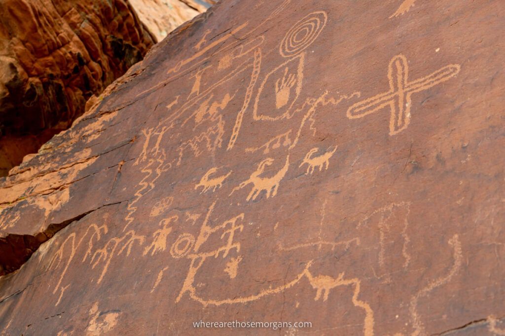 Petroglyphs at Atlatl Rock clear rock art drawings on red sandstone rock