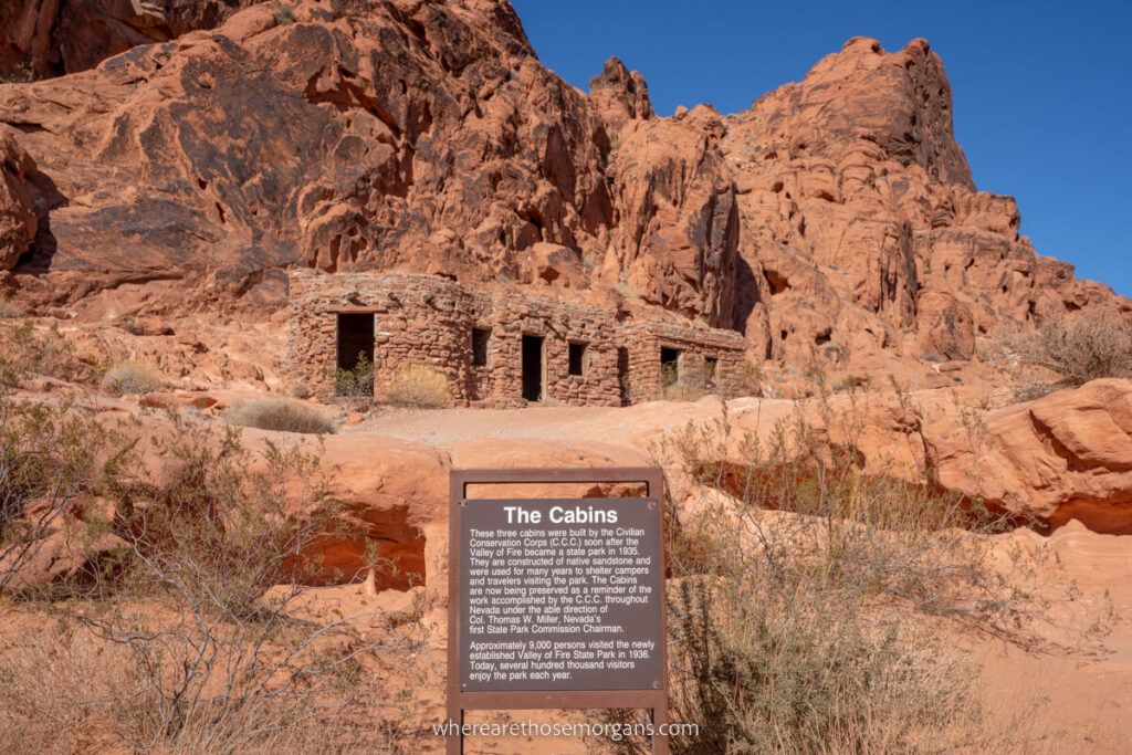 Historic Cabins made of red sandstone rocks in Nevada with an information board