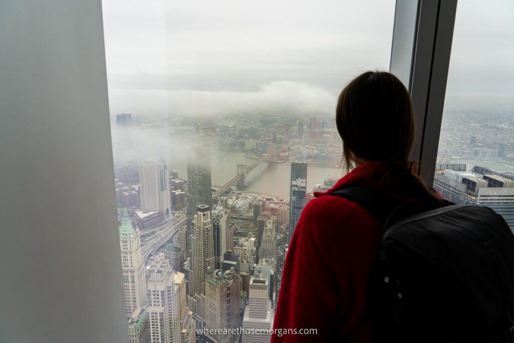 Woman looking out the window of One World Trade Center