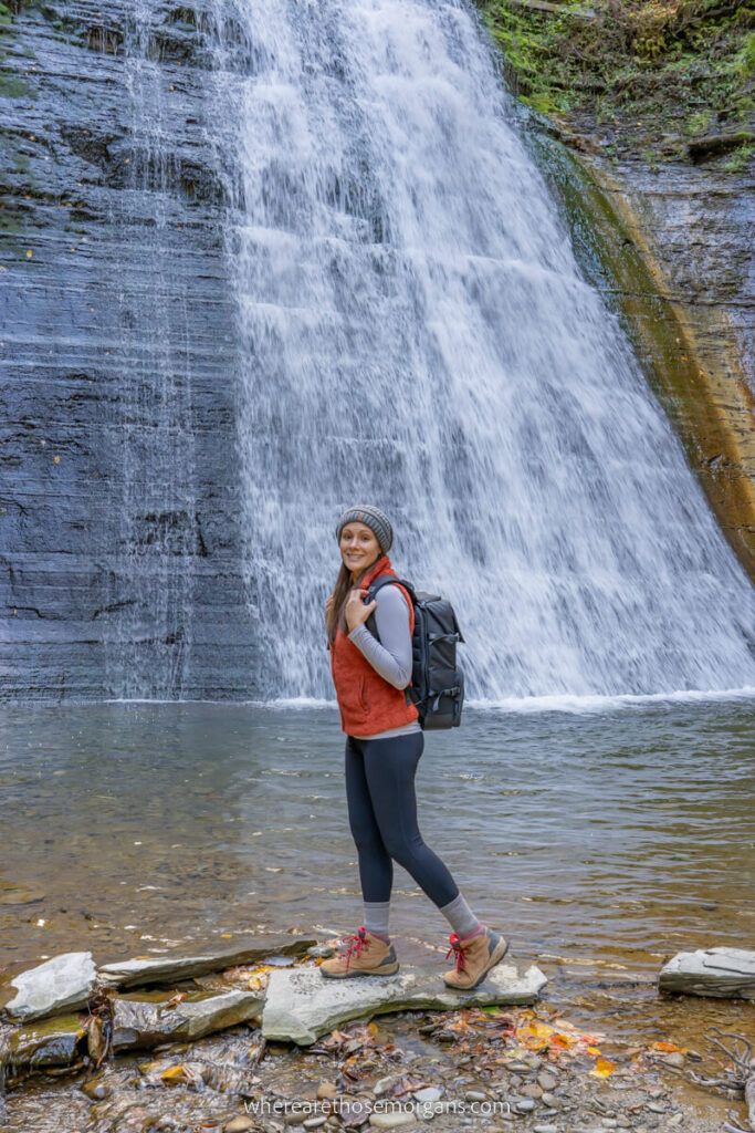 Woman walking by a waterfall with the Misshattan HEX Backpack