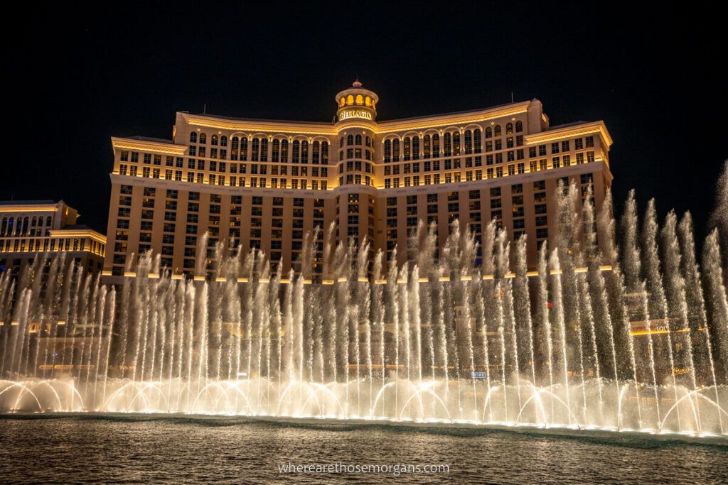 Bellagio fountain display lit up against the dark night sky