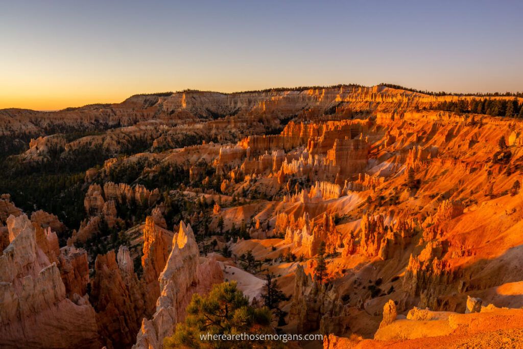 Bryce Canyon amphitheater at sunrise glowing red hoodoos needle like formations bursting into the purple sky worth the long day trip from Las Vegas