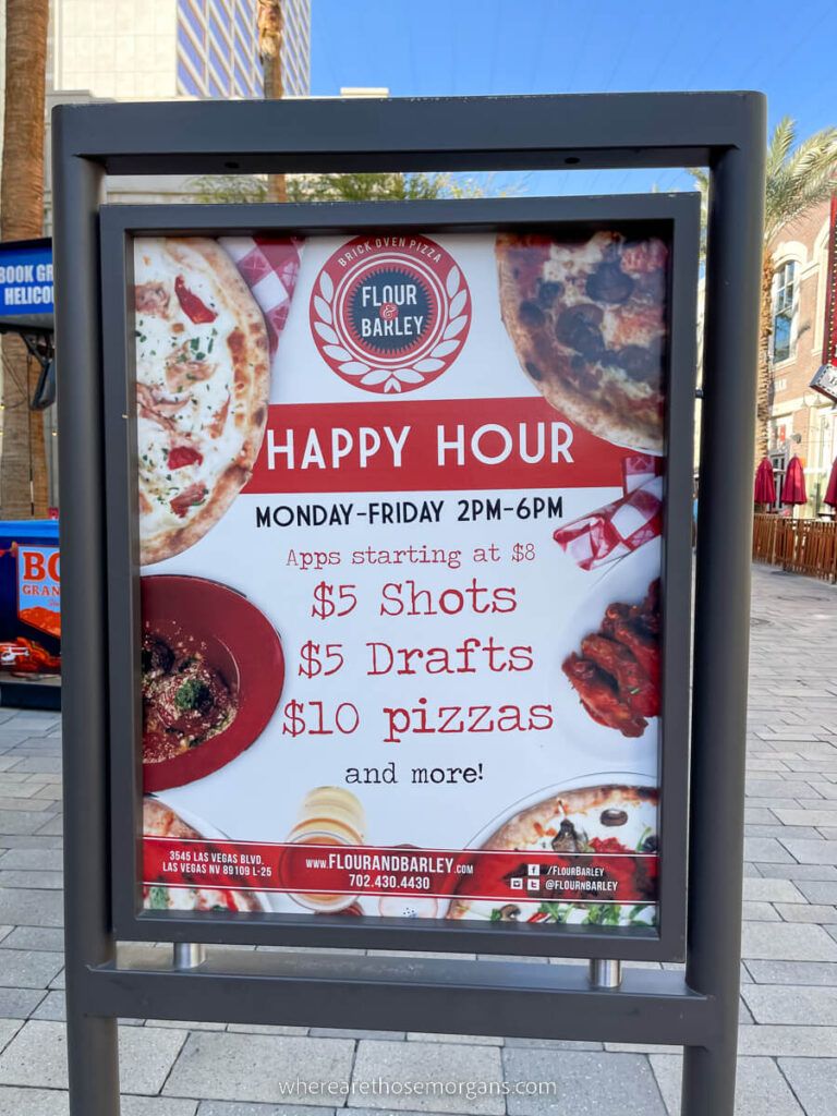 Happy Hour sign on the strip with discount prices listed