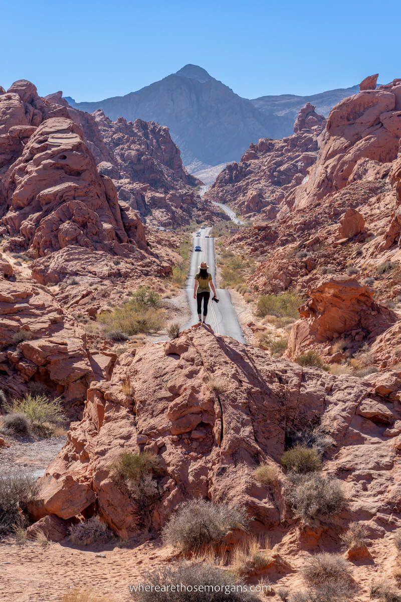 Hiker with camera at Mouse's Tank in Valley of Fire State Park near Las Vegas