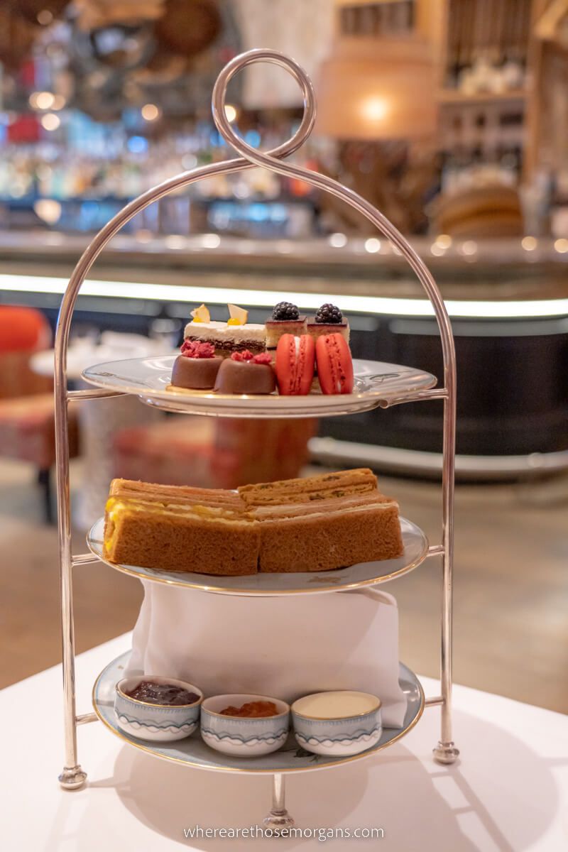 Afternoon tea tray with three tiers of scones sandwiches and desserts at the whitby hotel in nyc