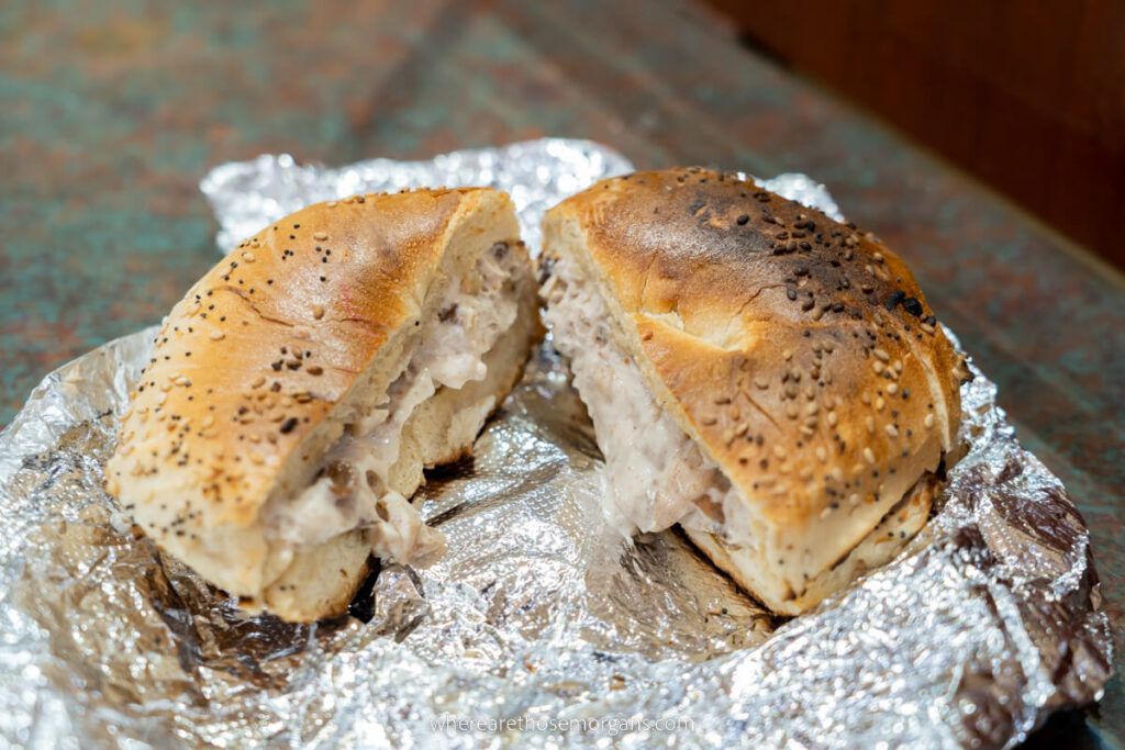 Classic NYC bagel cut in half with spread falling out