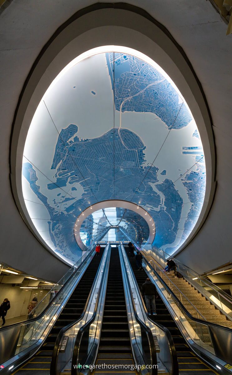 Escalators running up through a globe in Penn Station