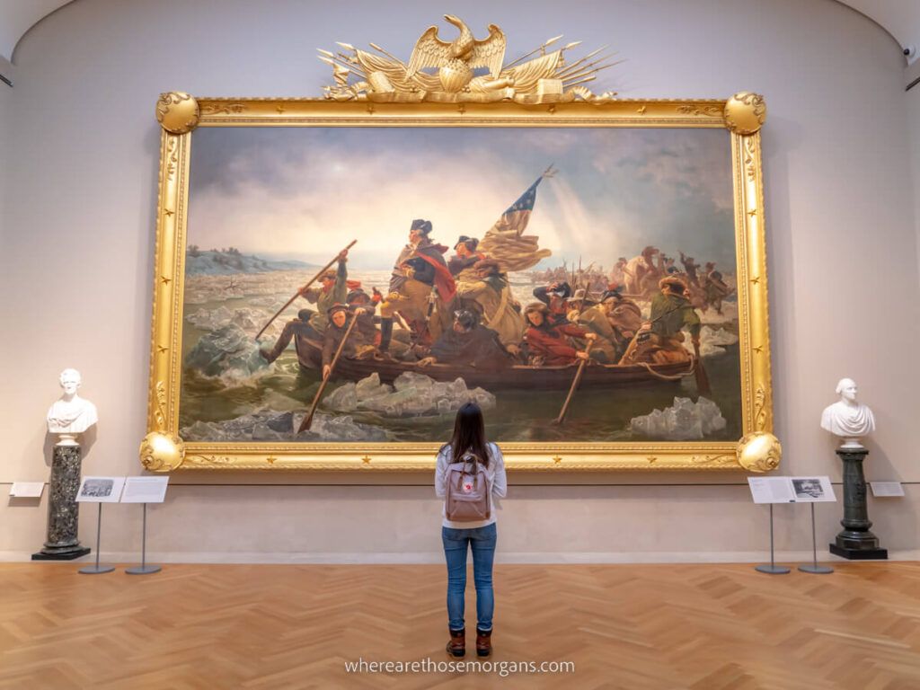 Woman stood looking at huge painting in The MET museum one of the best things to do in New York City