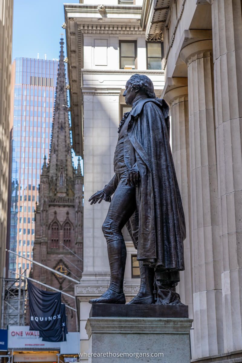 Statue of George Washington on Wall Street with Trinity Church in background