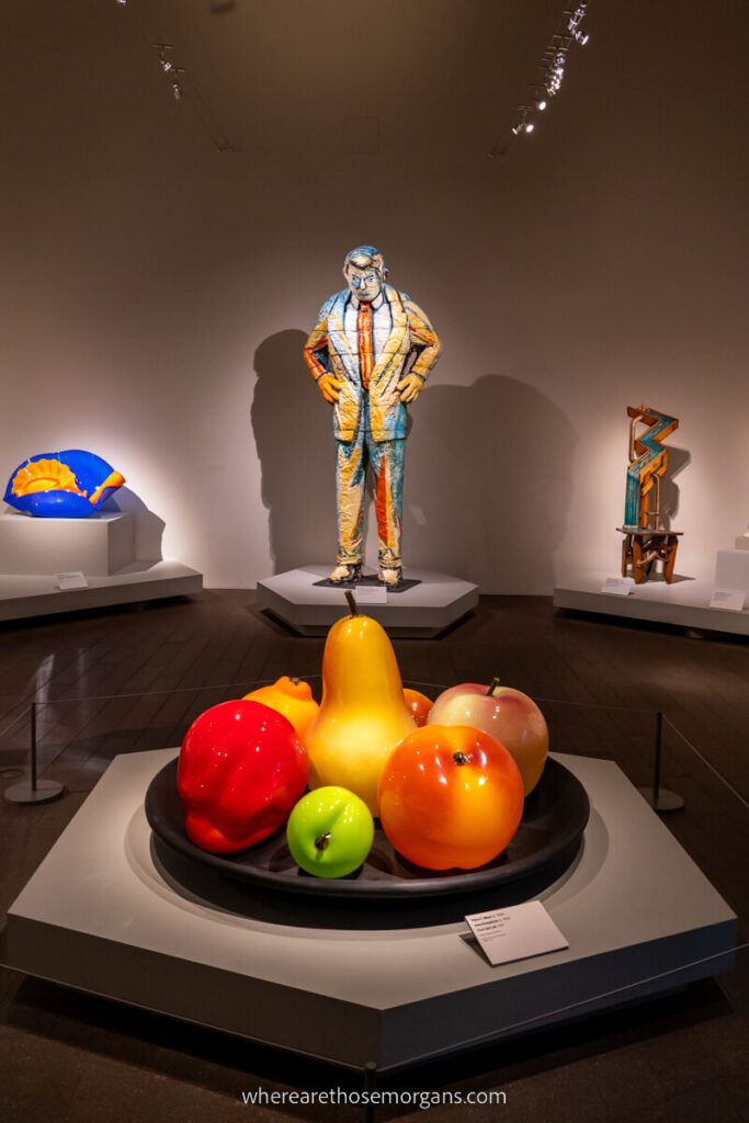 Colorful fruit bowl and additional statues at the De Young Museum