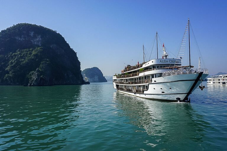 Junk boat floating in the emerald waters of Halong Bay