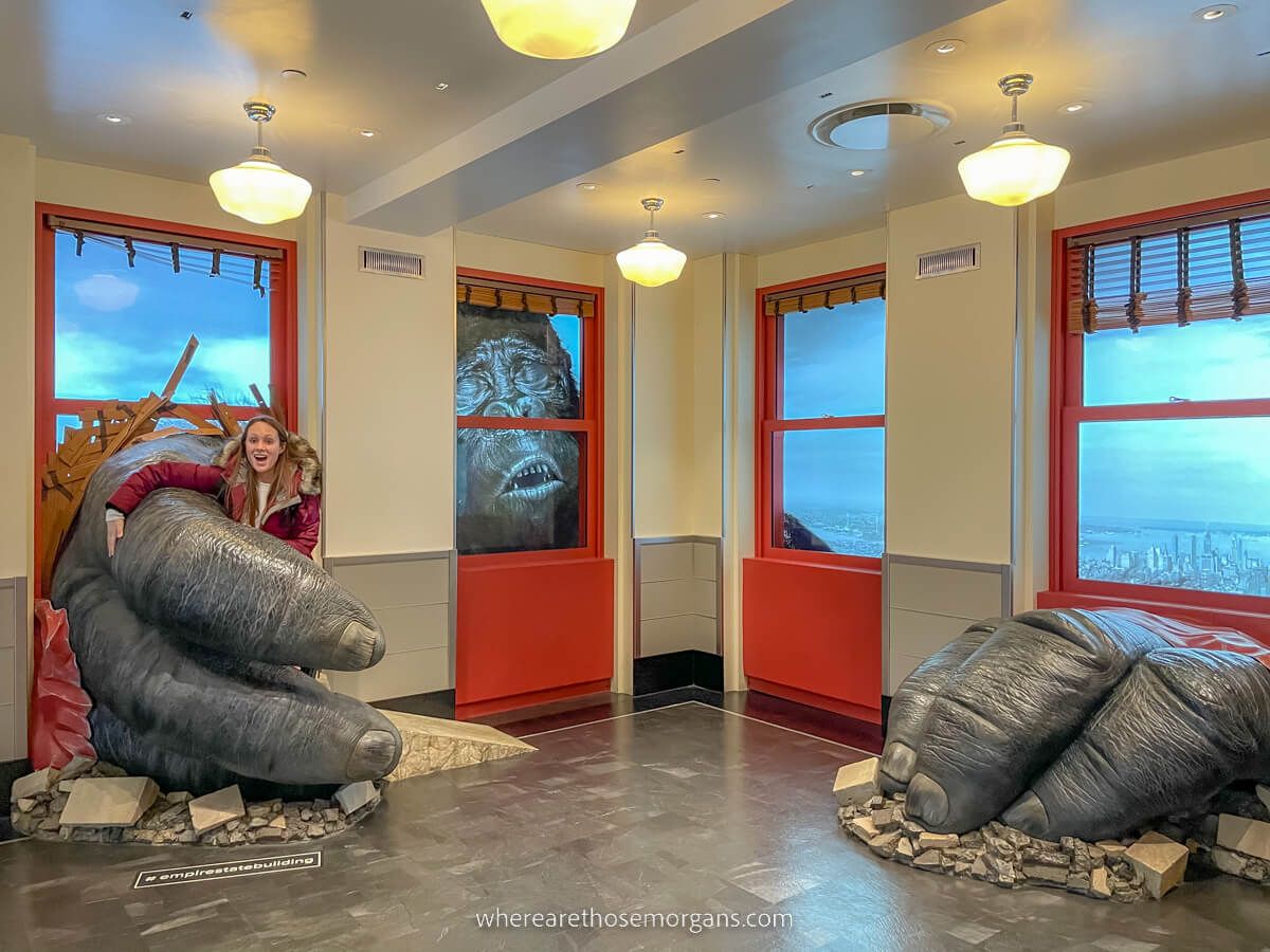 Woman sitting in King Kong's hand at the Empire State Building in New York City
