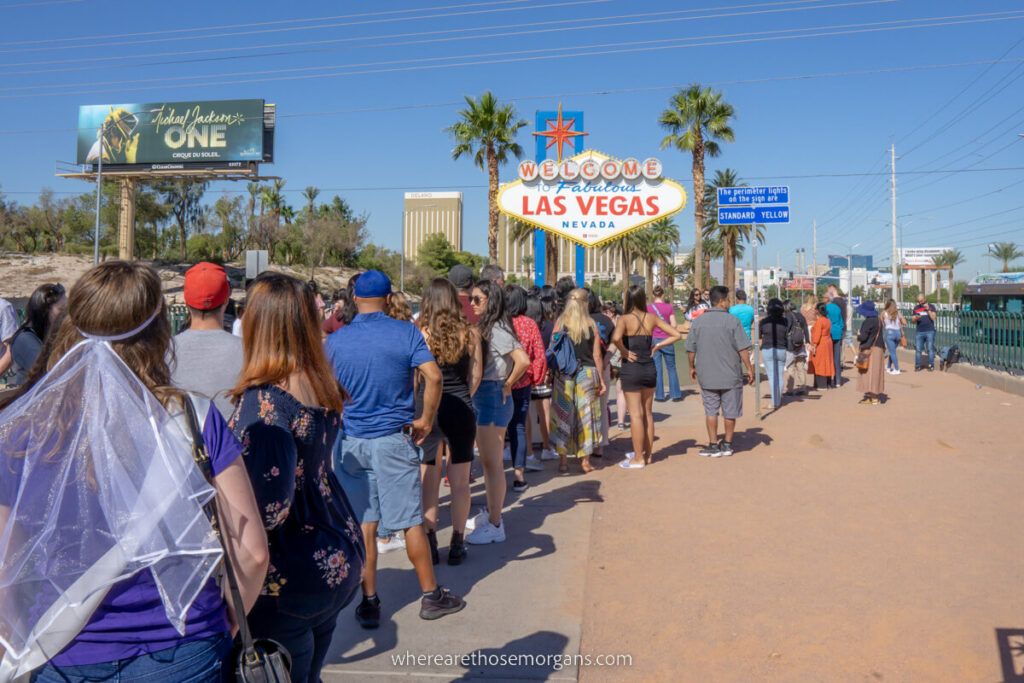 Long line to take a photo with the Las Vegas sign on a sunny day in November