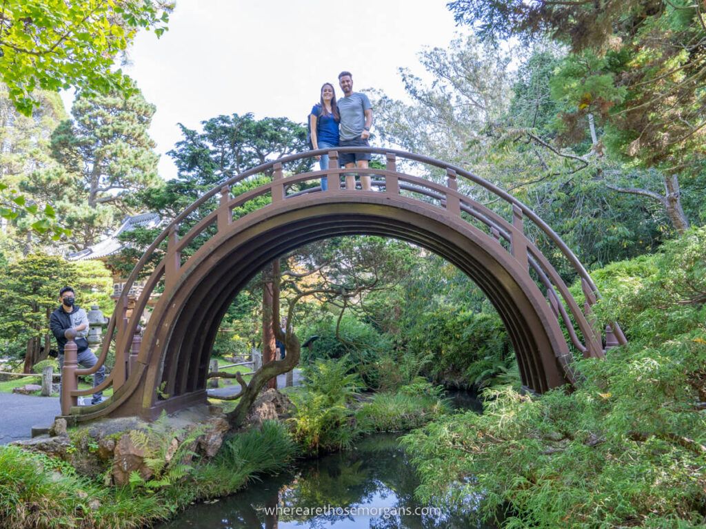 Woman and man posing for a photo on top of the drum bridge at the San Francisco Japanese Tea Garden