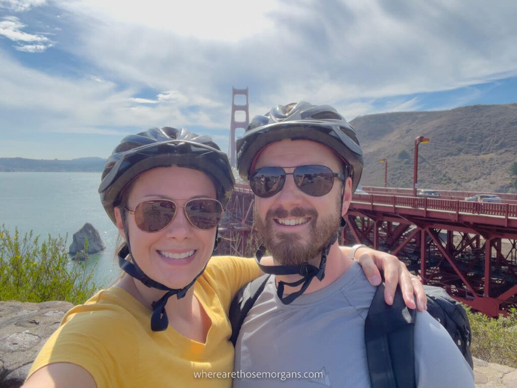 Man and woman posing for a photo after biking over the Golden Gate Bridge