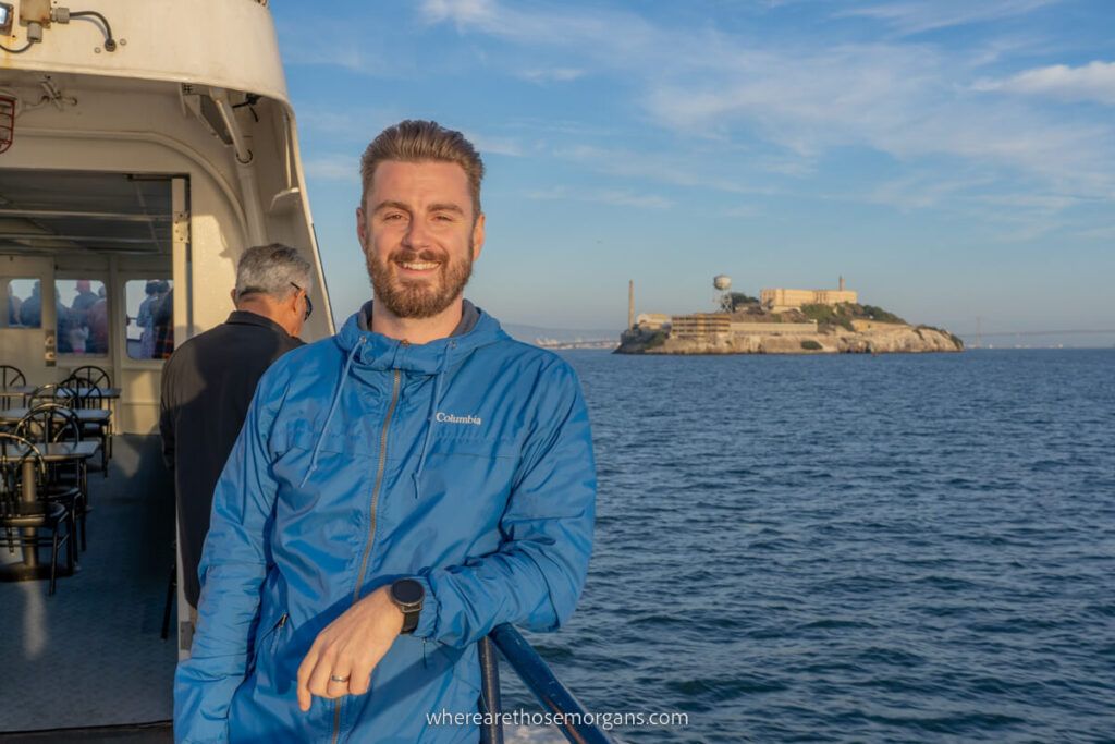 Man posing with the Island of Alcatraz on a Blue and Gold Fleet Cruise