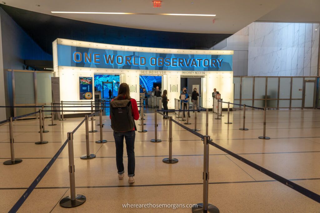 Woman walking to One World Observatory ticket desk with no crowds