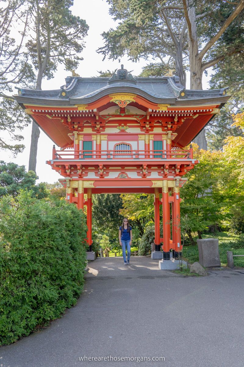 Woman standing under a large red pagoda
