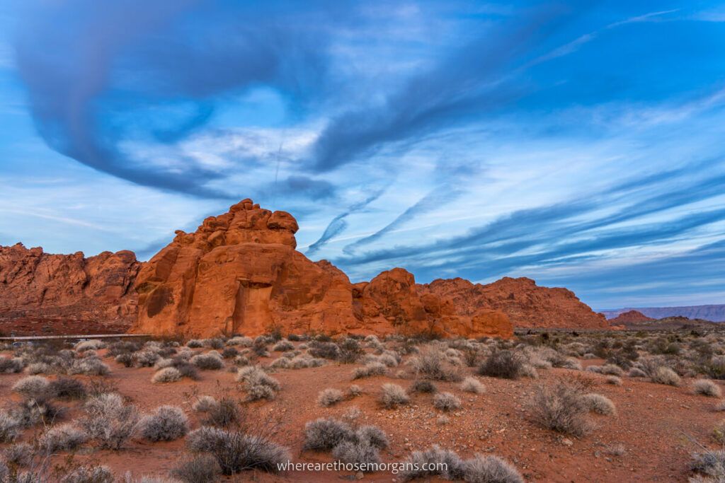 Seven sisters rock formations in Nevada under an intense blue sky with swirling clouds at dusk
