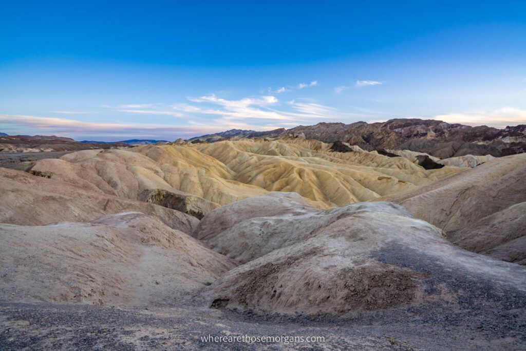 Unique landscape filled with rolling yellow mounds leading to a deep blue sky