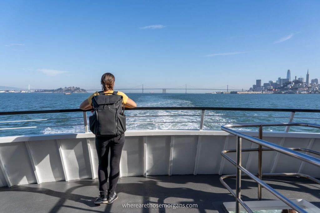 Woman looking out at the city of San Francisco from the back of an Alcatraz Cruise
