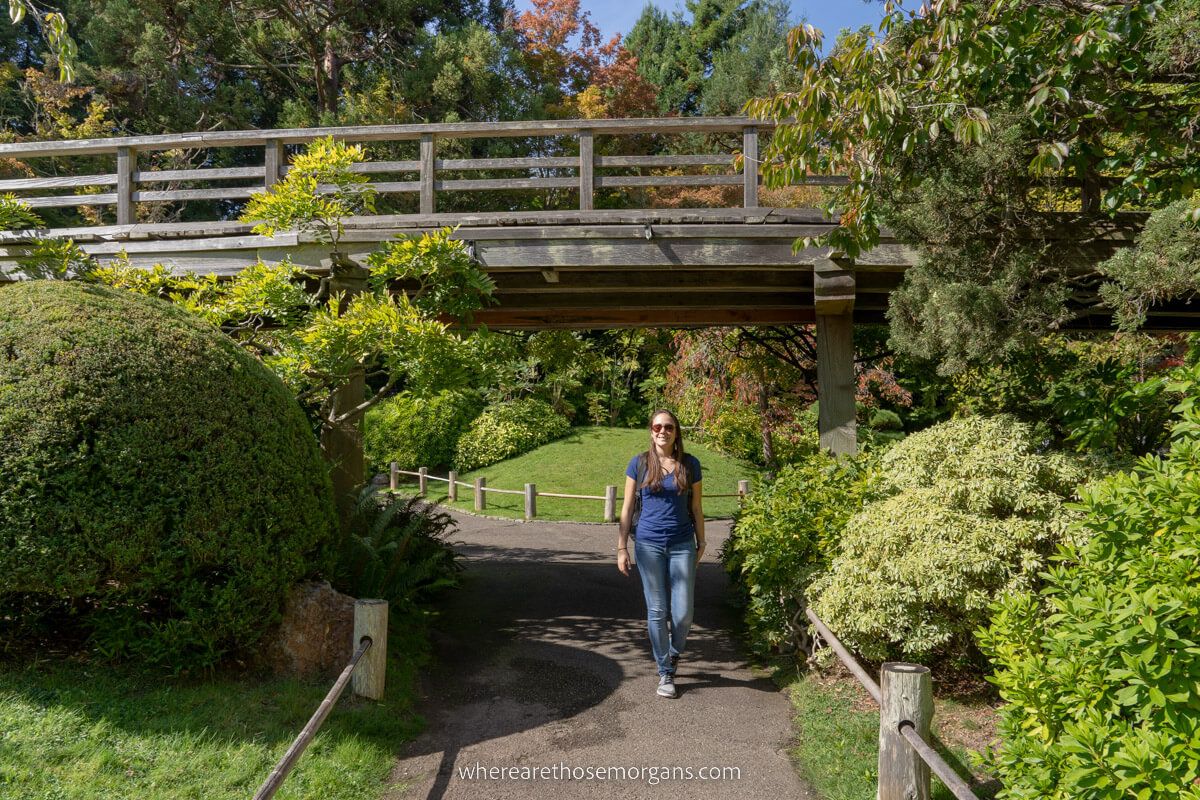 Woman standing under a bridge in the sun at the San Francisco Japanese Tea Garden