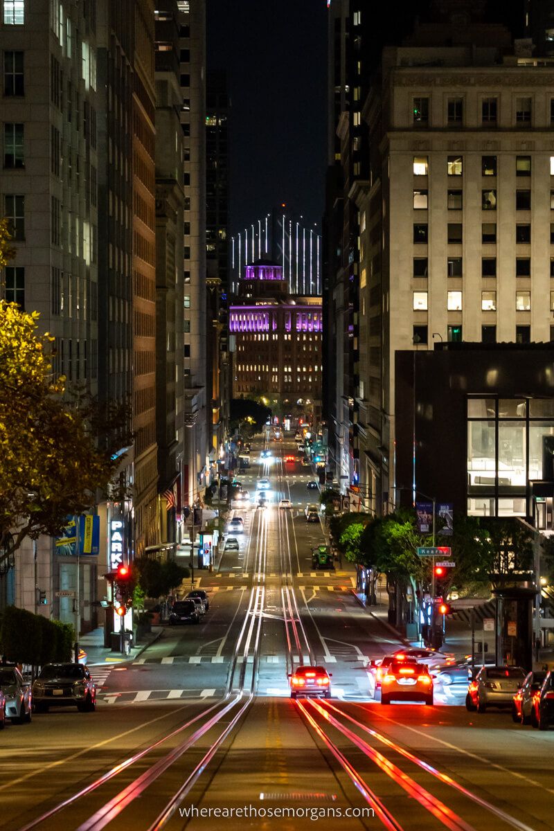 California Street SF Oakland Bridge view at night with cars and tram lines completely free thing to do in San Francisco