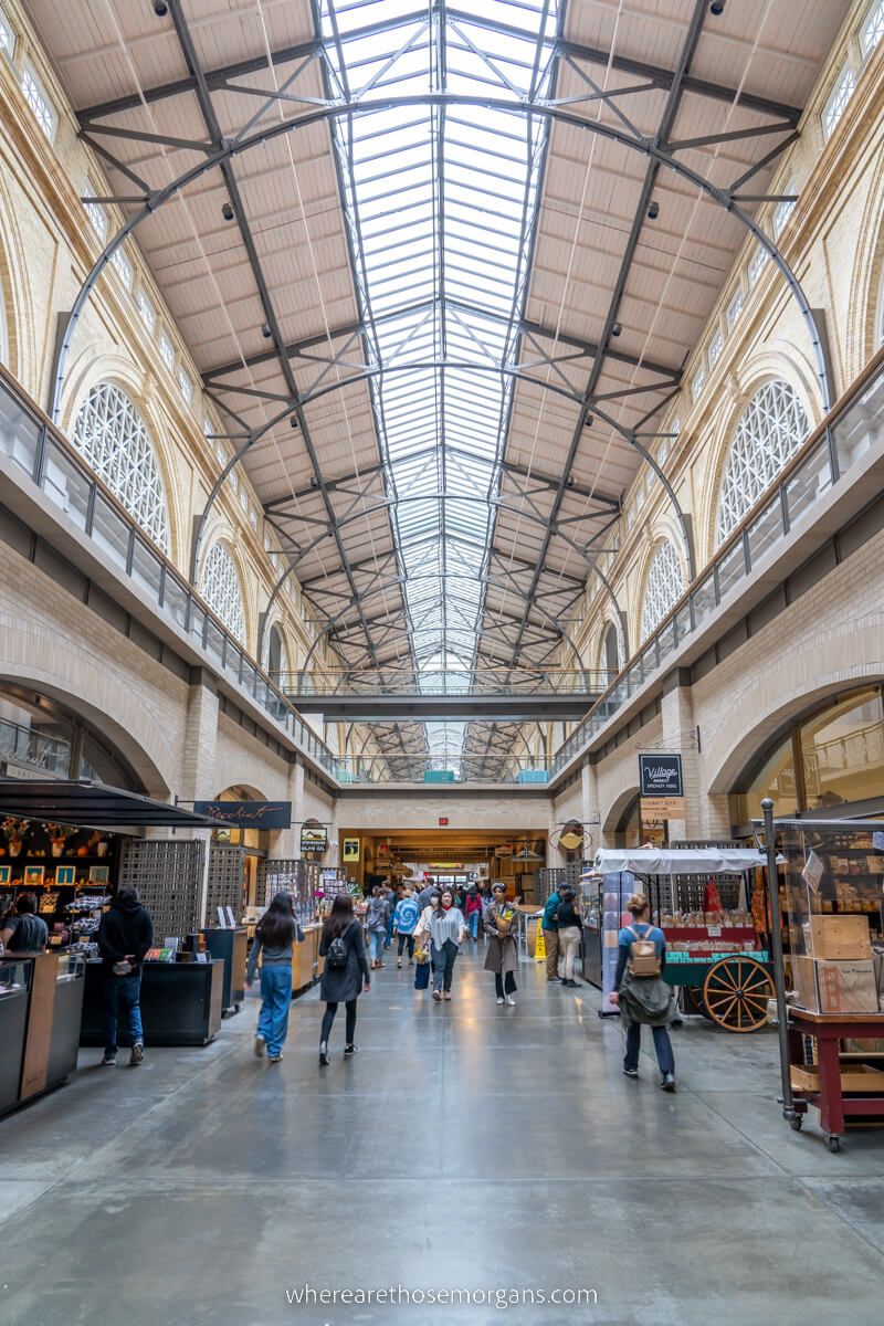 Inside Ferry Building Marketplace tall curving roof with vendors selling goods