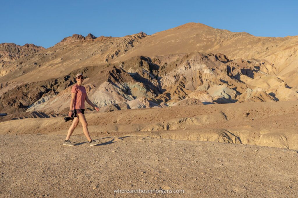 Woman walking on yellow dirt near Artists Palette in Death Valley on a day trip from Las Vegas