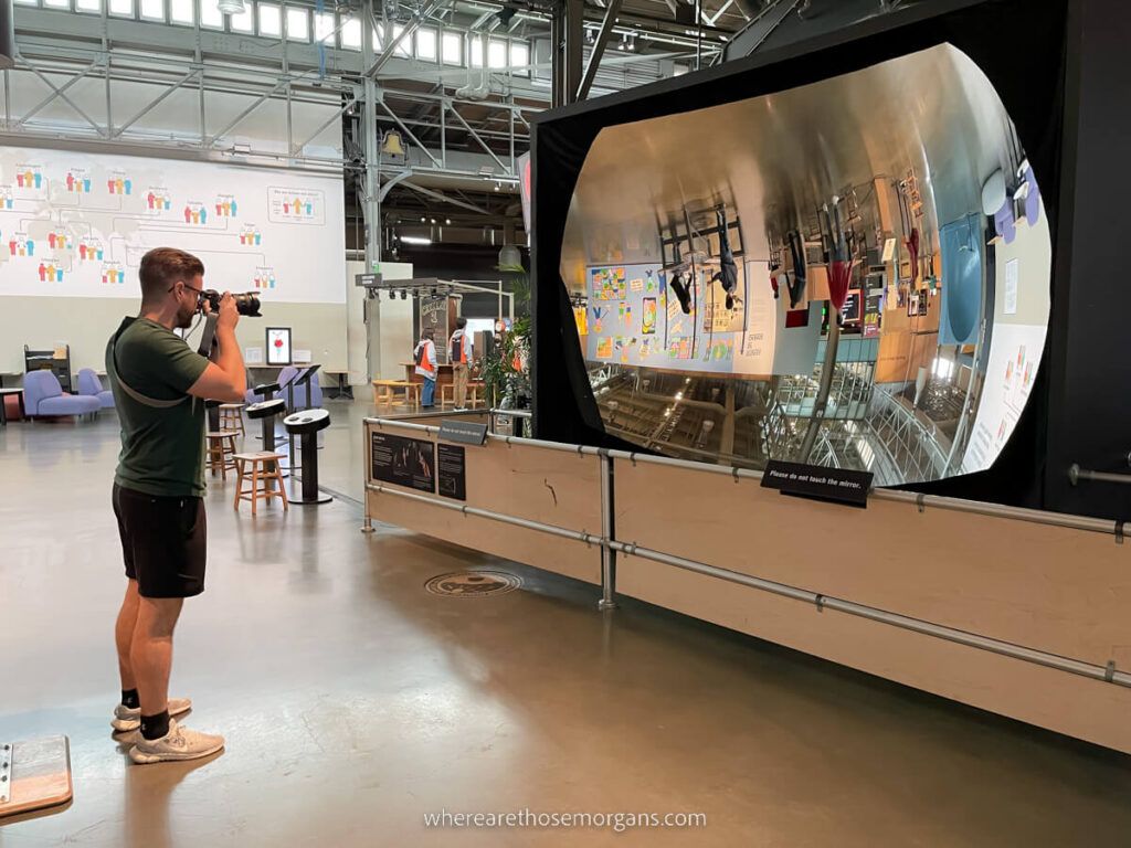 Man taking a photo in a large mirror