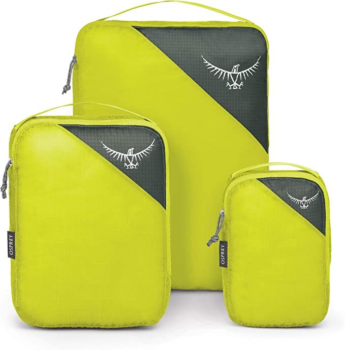 Three green osprey packing cubes used for traveling