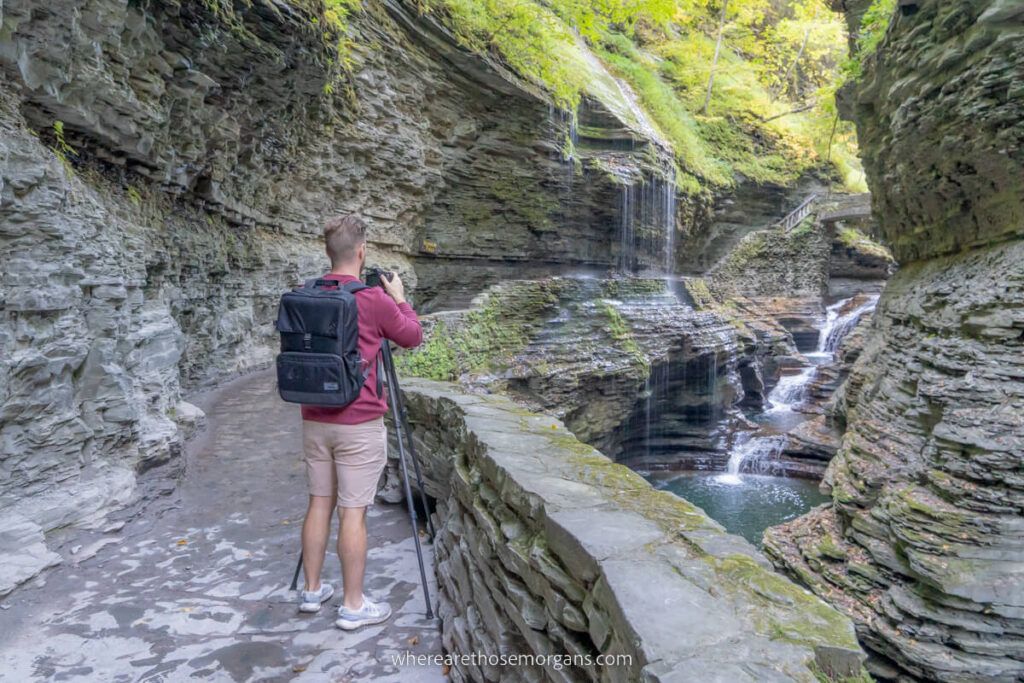 Photographer with camera and tripod at Rainbow Falls in Watkins Glen State Park ny