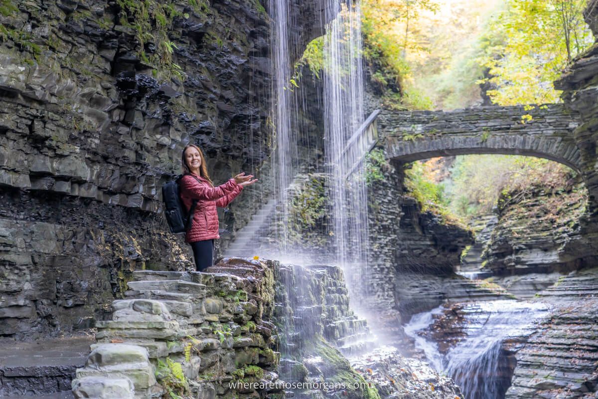 Woman holding hands under a waterfall in upstate new york
