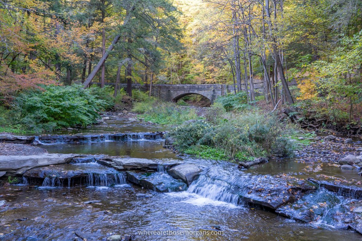 Stone bridge and cascading waterfall at Wolf Creek