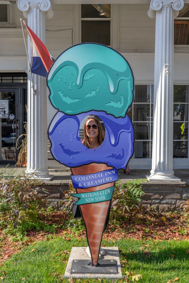 Woman poking her head through an ice cream sign at the Colonial Inn Creamery