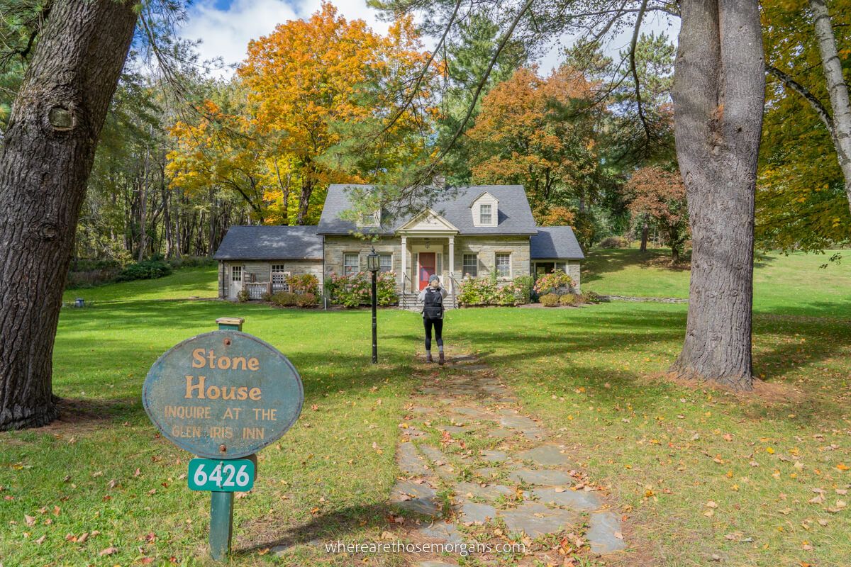 Woman walking up the path to the stone house at Letchworth State Park