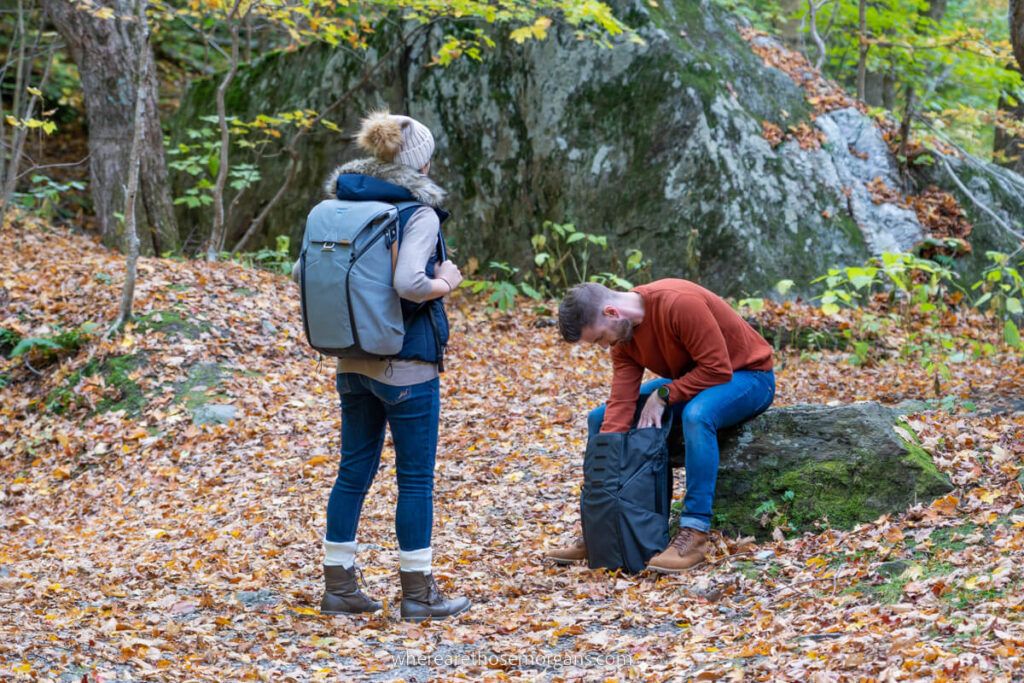 Couple packing their peak design camera during a photography trip